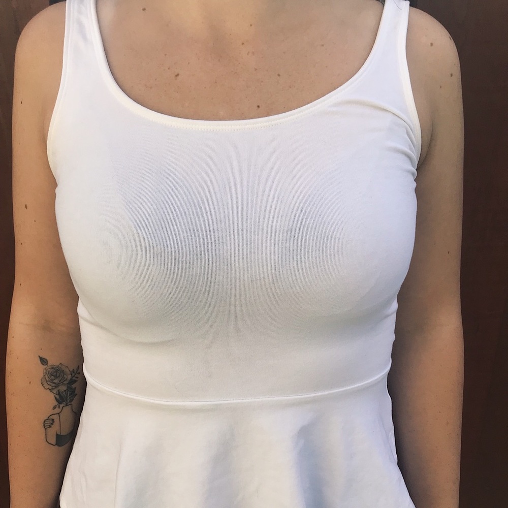 White sleeveless peplum top .